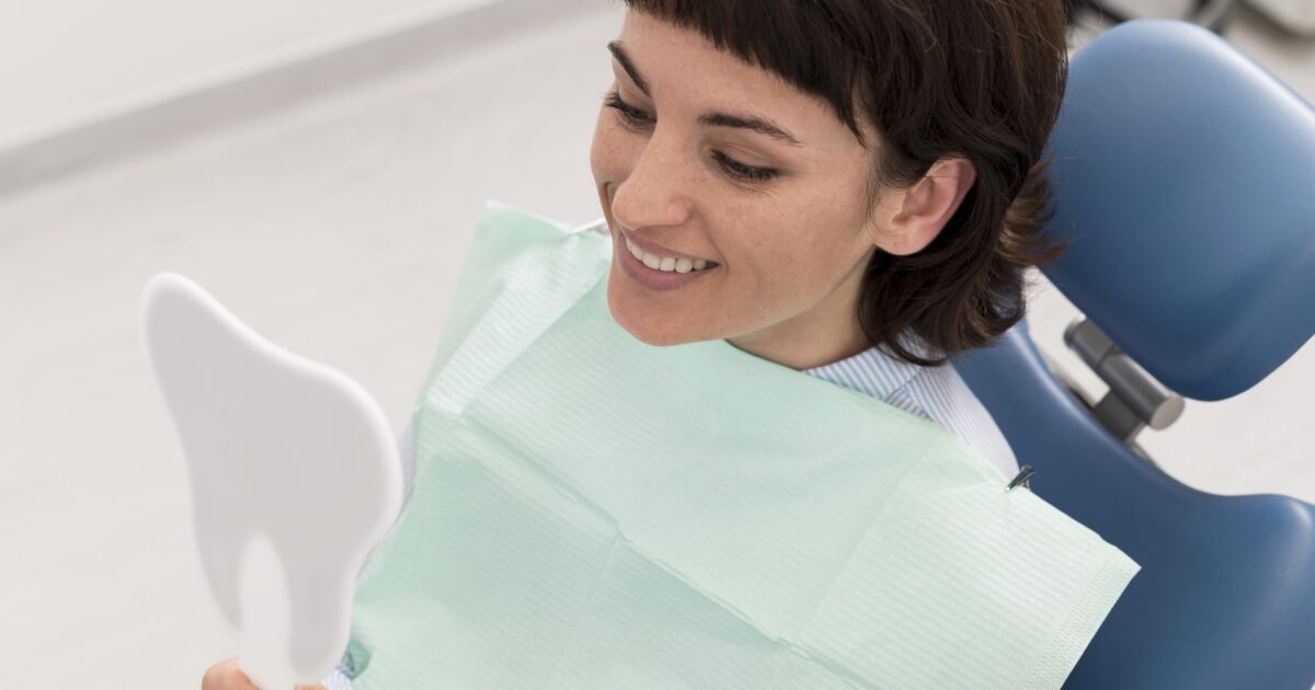 female-patient-looking-mirror-after-dental-procedure